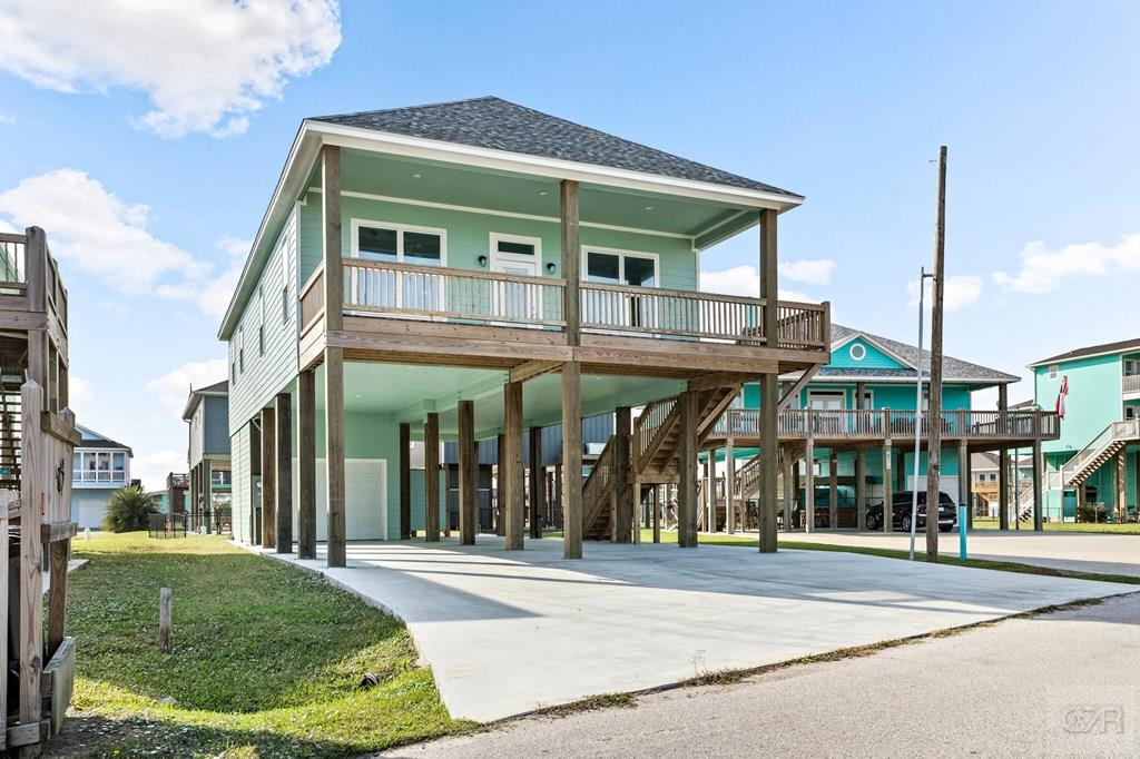 971 Tidelands Crystal Beach, TX 77650 - Photo 3 of 38 a view of a building with a yard