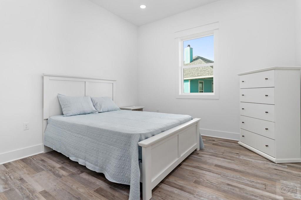 971 Tidelands Crystal Beach, TX 77650 - Photo 31 of 38 a bedroom with a bed and a window