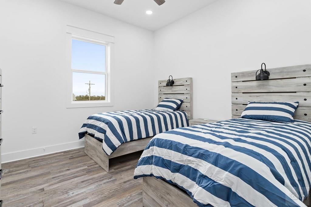 971 Tidelands Crystal Beach, TX 77650 - Photo 33 of 38 a bedroom with two beds and a night stand