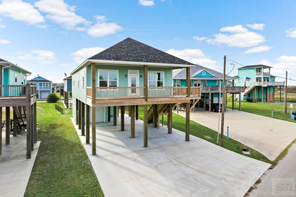 971 Tidelands Crystal Beach, TX 77650 - Photo 4 of 38 a front view of a house with a yard