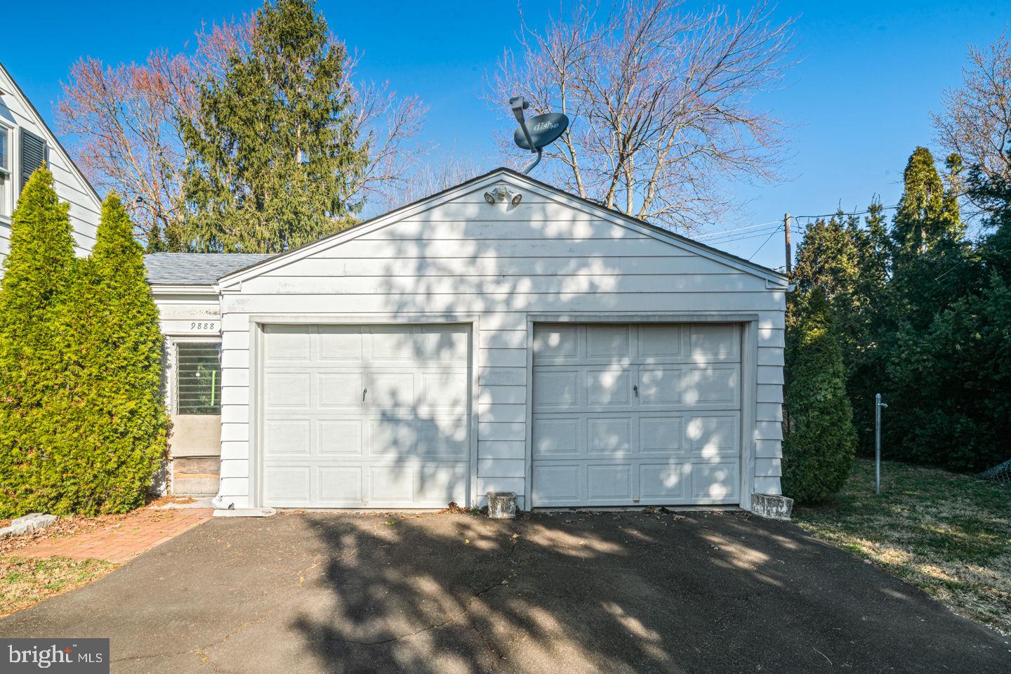 9888 Verree Road Philadelphia, PA 19115 - Photo 3 of 13 a front view of a house with a yard and garage