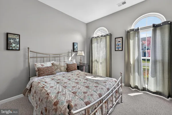 a bedroom with a bed and a lamp