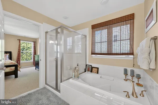a bathroom with a double vanity sink a mirror and a bathtub