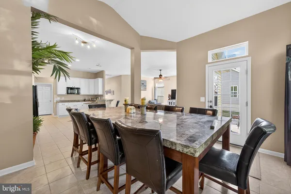 a kitchen with granite countertop white cabinets and stainless steel appliances