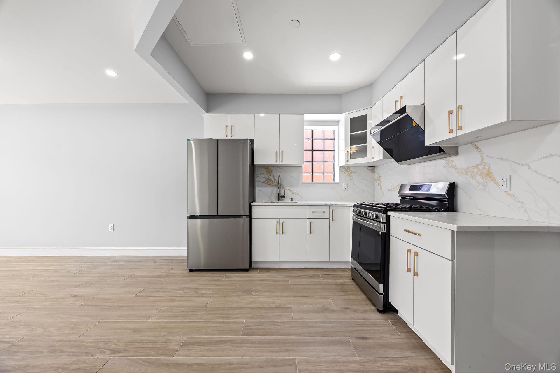 132-25 41st Avenue, Unit 3A Queens, NY 11355 - Photo 7 of 12 a kitchen with a refrigerator and a sink