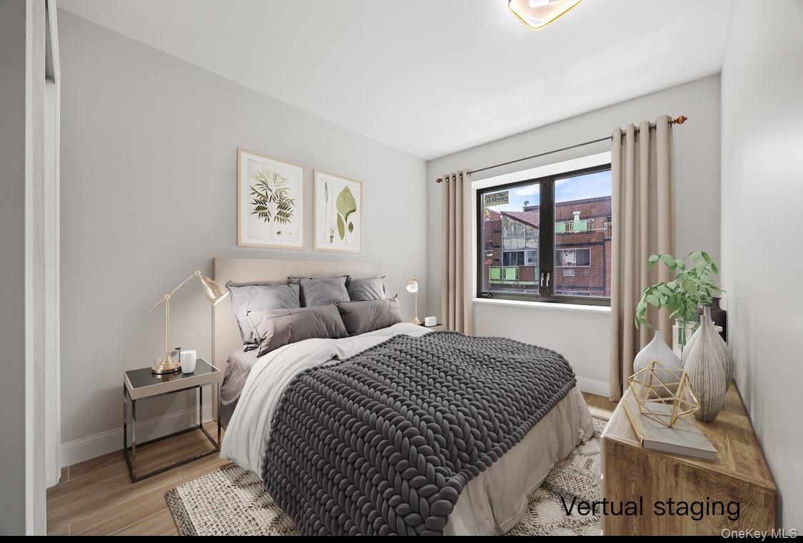 132-25 41st Avenue, Unit 3A Queens, NY 11355 - Photo 9 of 12 a bedroom with a bed and a window
