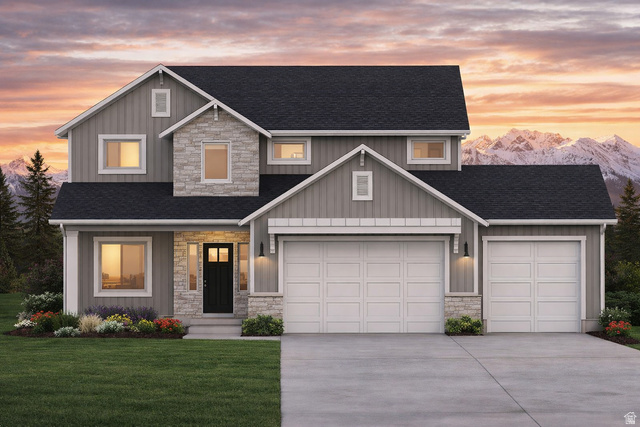 3318 South 1000 West Logan, UT 84321 - Photo 3 of 12 Contemporary home featuring a stone and siding exterior, a dark shingle roof, an attached two-car garage, and a manicured lawn with planted landscaping