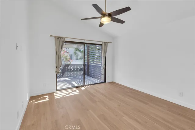 an empty room with wooden floor and closet
