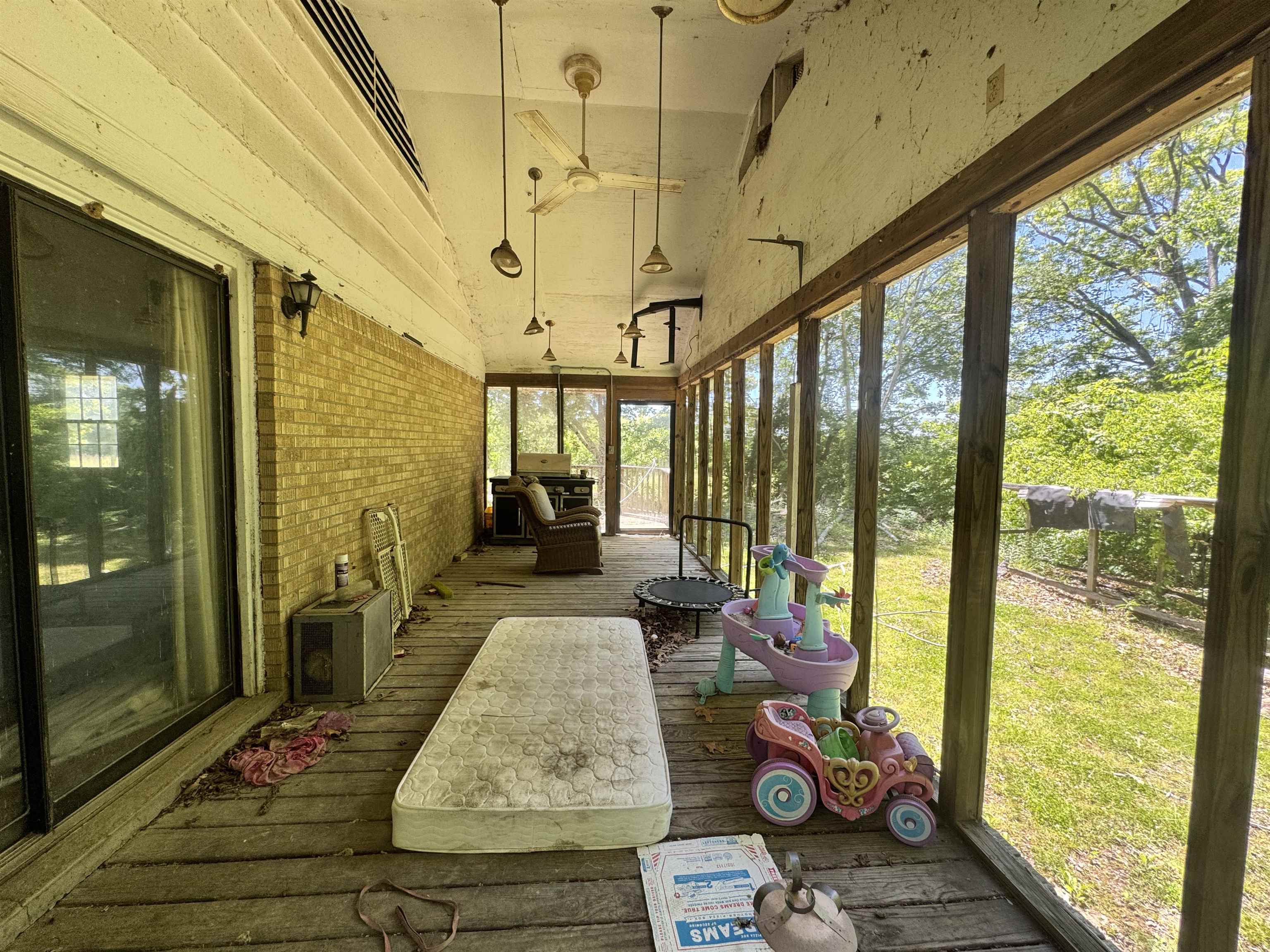 4712 Drummonds Road Drummonds, TN 38023 - Photo 33 of 38 Screened porch featuring wood-finish flooring and a brick wall
