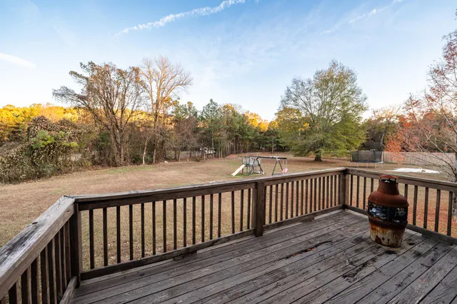 a view of balcony with wooden floor and fence