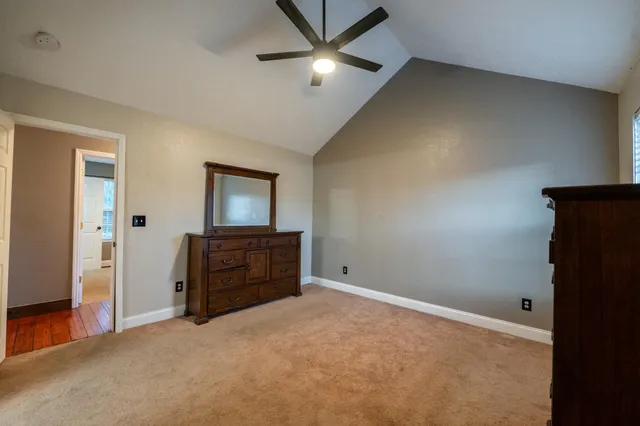 an empty room with closet and fan