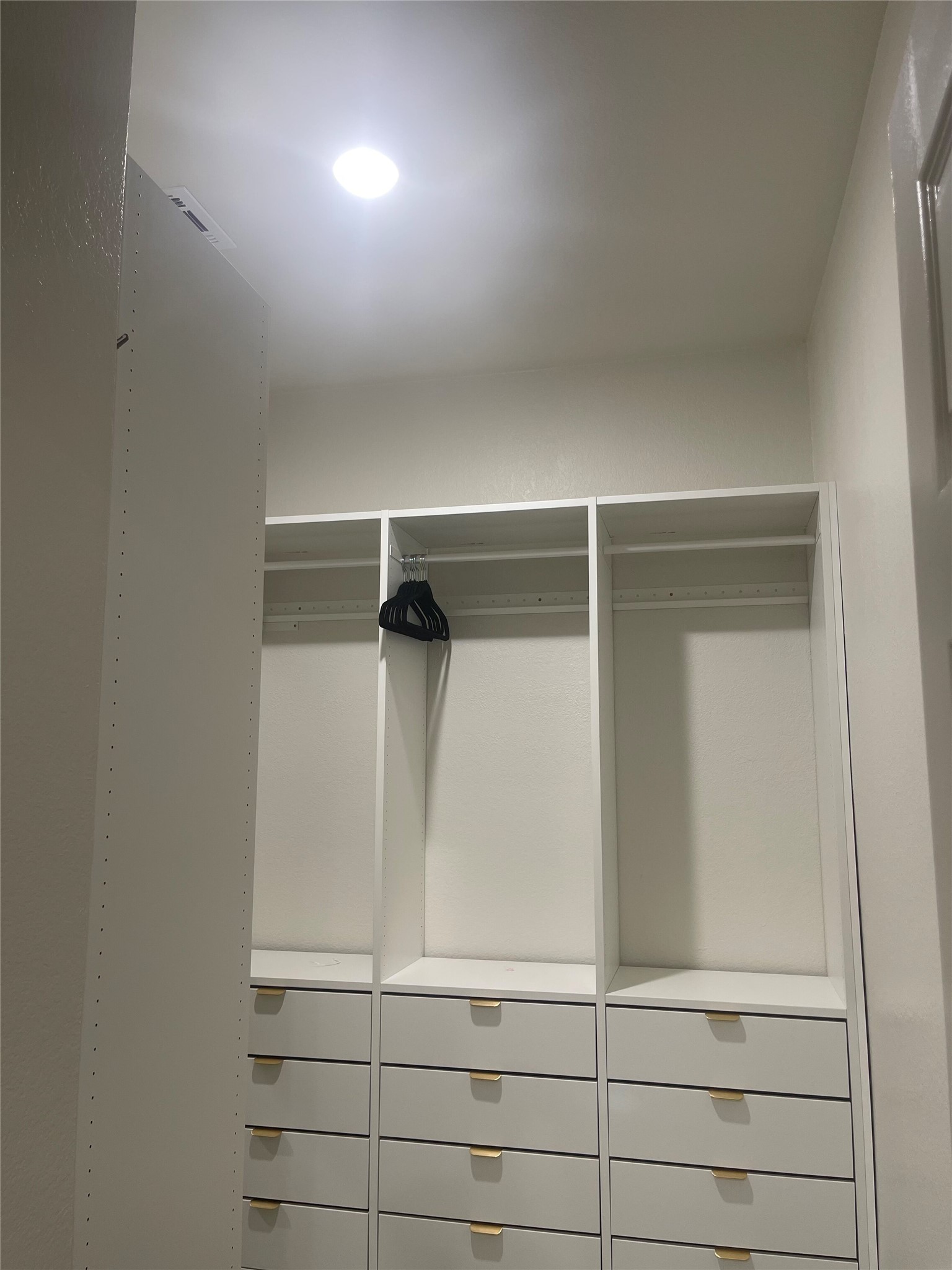 145 Merrick Road Georgetown, TX 78628 - Photo 20 of 32 Custom built-in drawers and shelving optimize space in this recessed-lit walk-in closet.