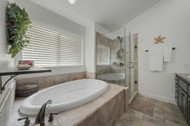 a bathroom with a tub and shower