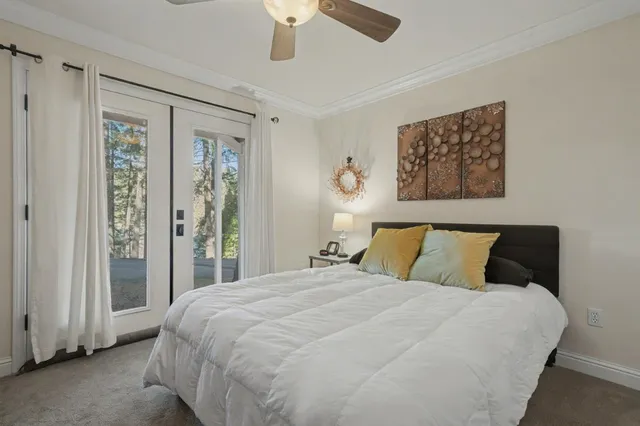 a bedroom with a large bed and a chandelier