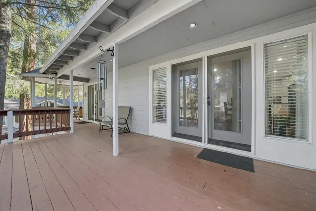 a view of an empty room with wooden floor and a balcony