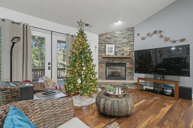 a living room with furniture a flat screen tv and a fireplace