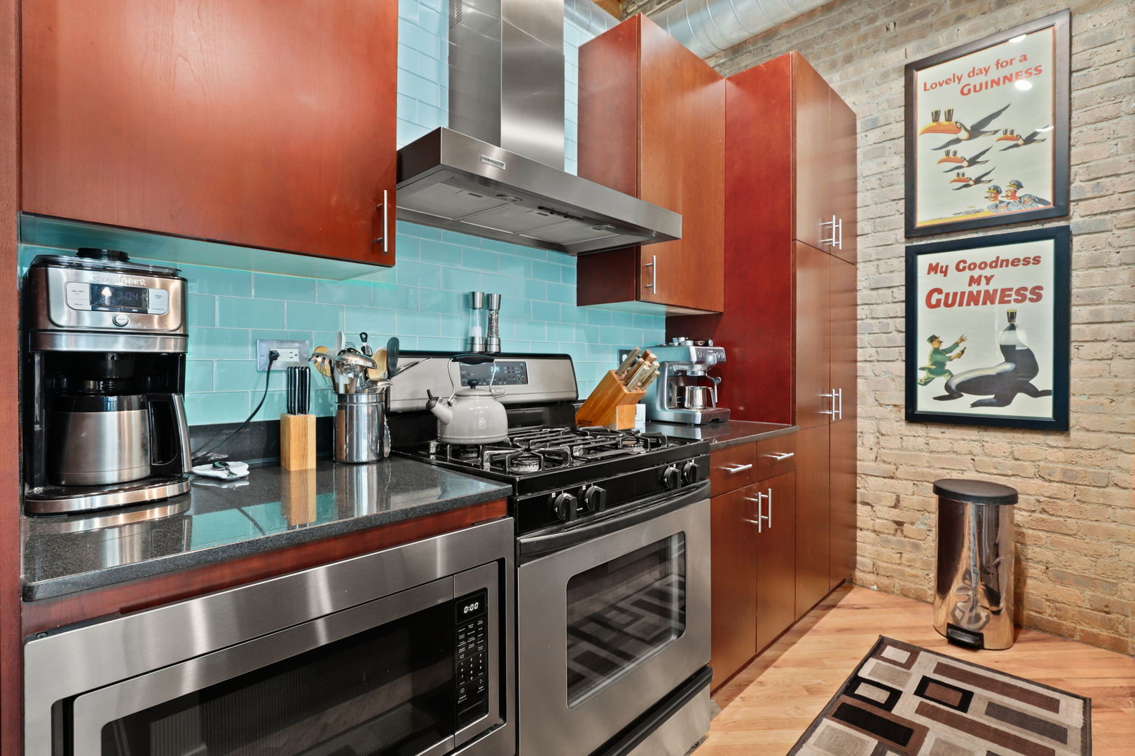 1040 West Adams Street, Unit 224 Chicago, IL 60607 - Photo 11 of 32 a kitchen with stainless steel appliances granite countertop a stove and a microwave