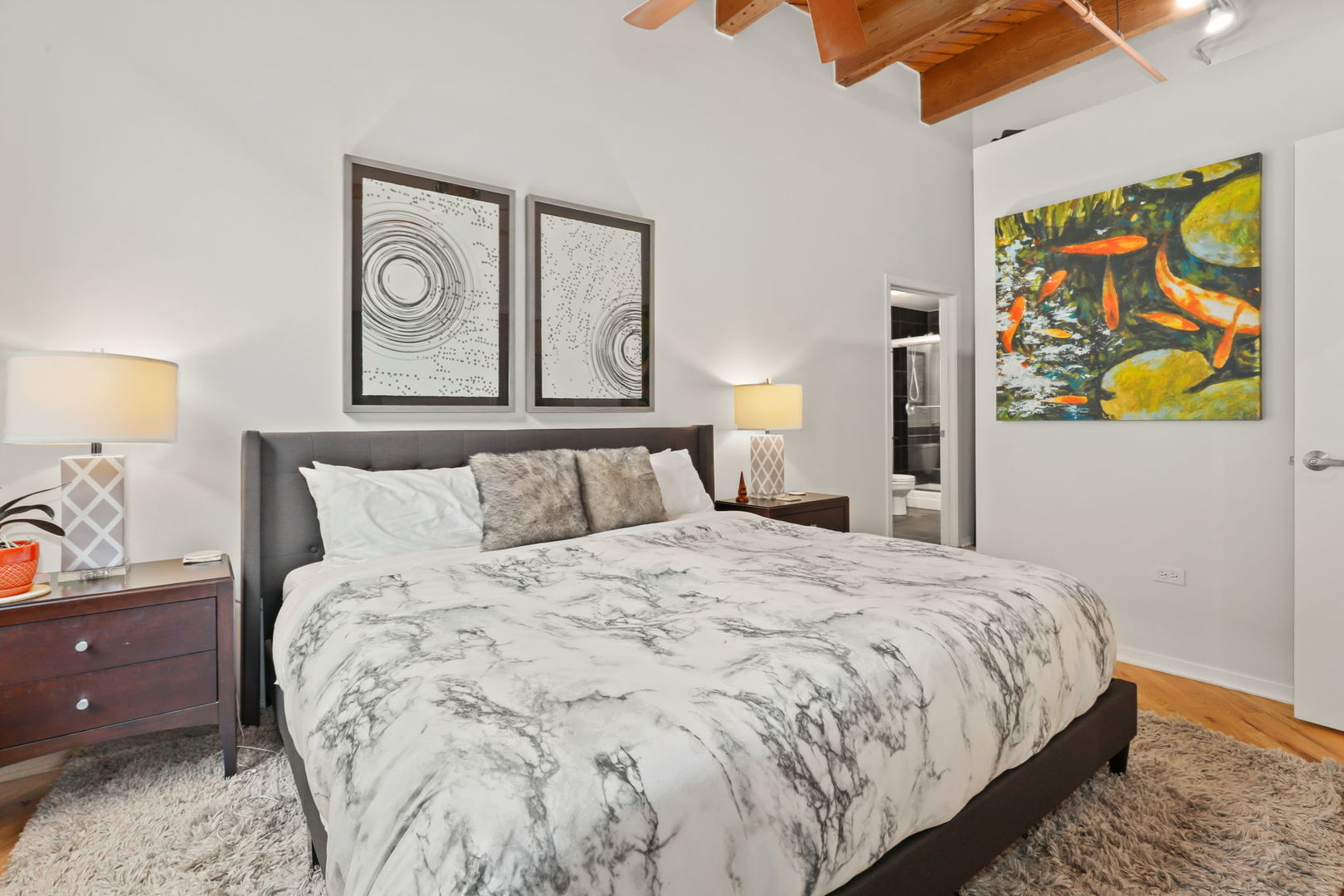 1040 West Adams Street, Unit 224 Chicago, IL 60607 - Photo 15 of 32 a bedroom with a bed and painting on the wall