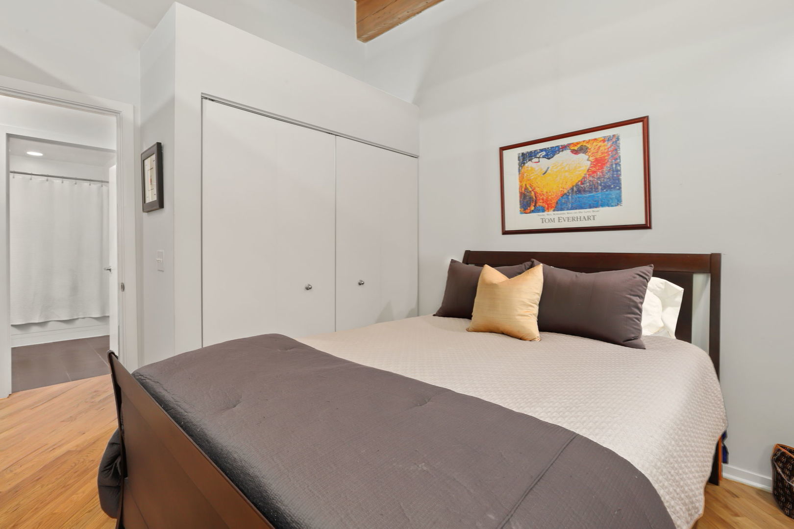 1040 West Adams Street, Unit 224 Chicago, IL 60607 - Photo 19 of 32 a bedroom with a bed and a painting on the wall