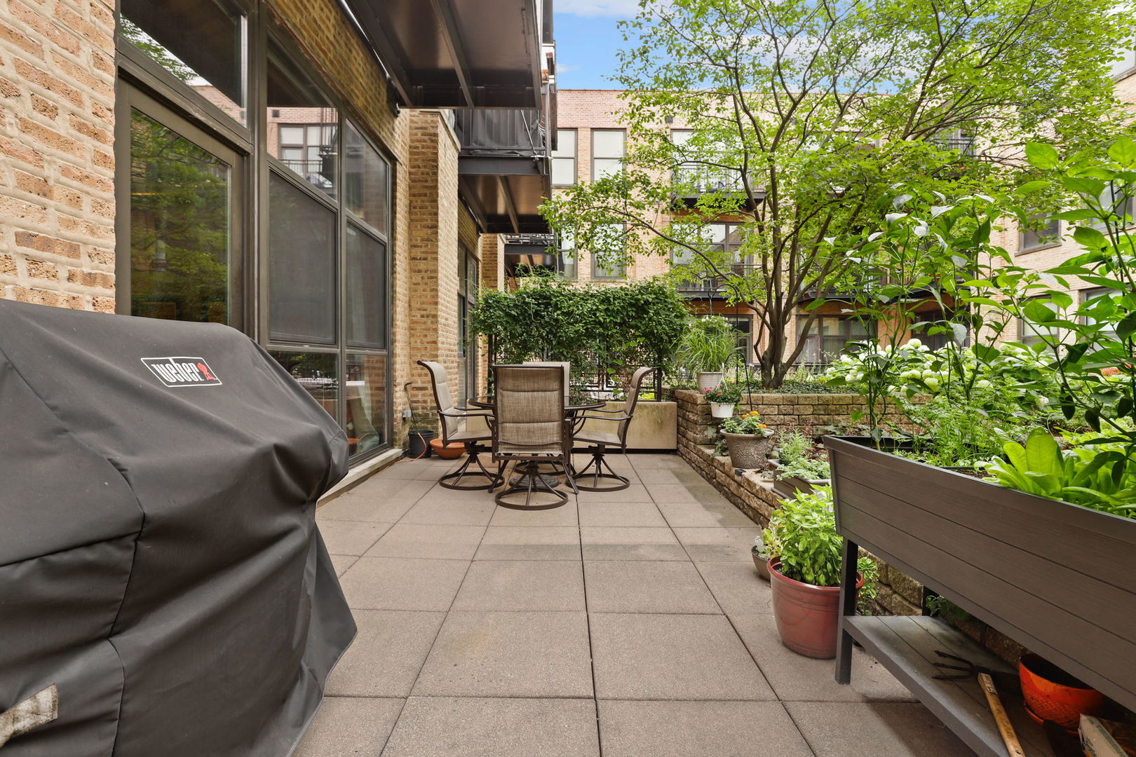 1040 West Adams Street, Unit 224 Chicago, IL 60607 - Photo 23 of 32 a view of a patio with table and chairs and potted plants