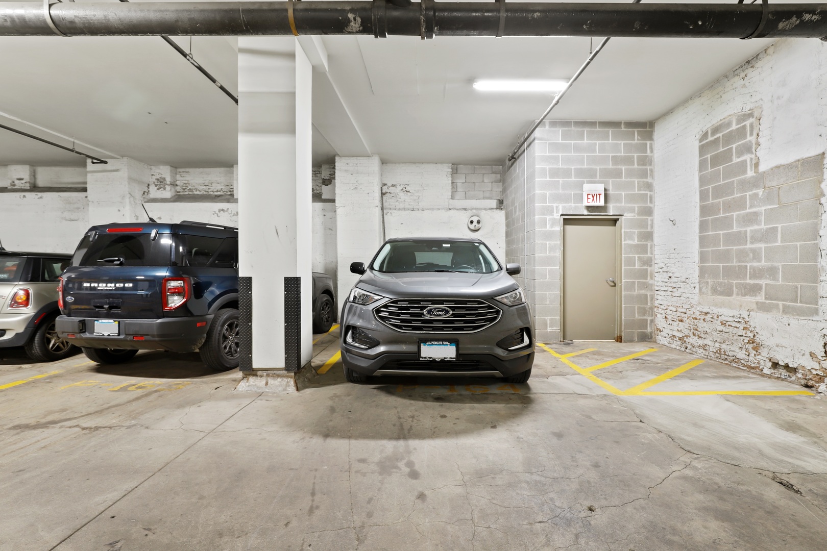 1040 West Adams Street, Unit 224 Chicago, IL 60607 - Photo 30 of 32 a car parked in a parking