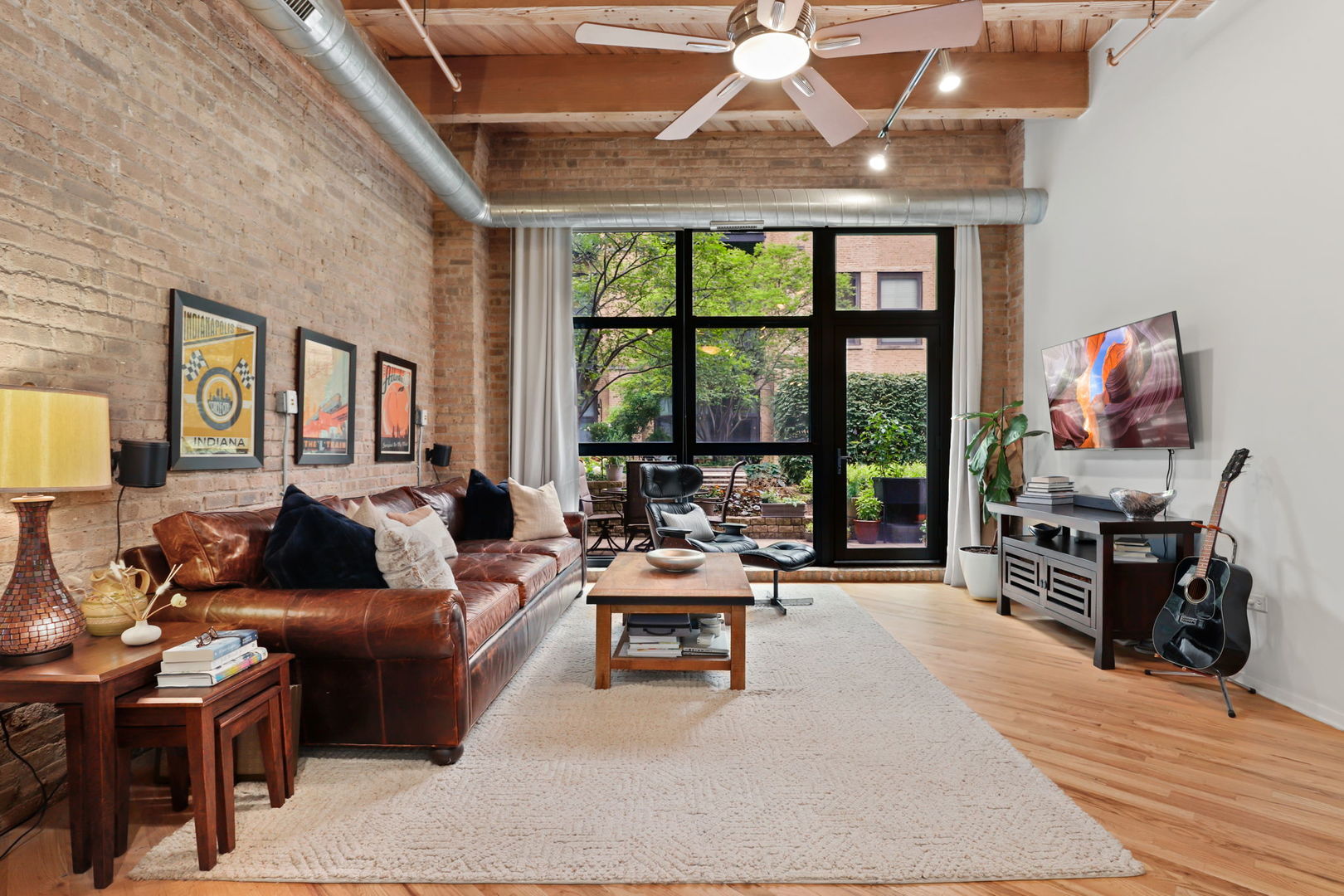 1040 West Adams Street, Unit 224 Chicago, IL 60607 - Photo 4 of 32 a living room with furniture and a flat screen tv