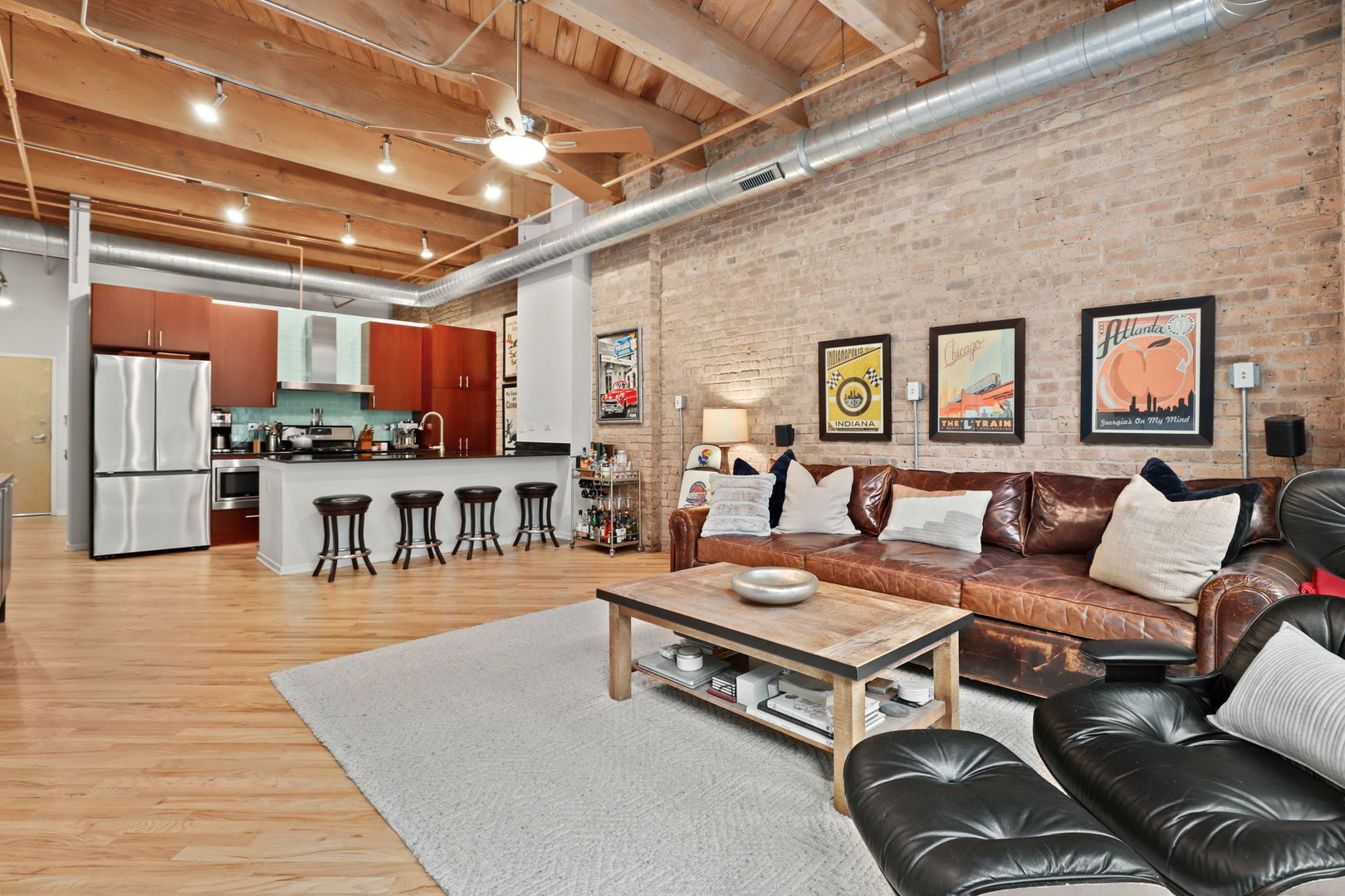 1040 West Adams Street, Unit 224 Chicago, IL 60607 - Photo 6 of 32 a living room with furniture and a view of kitchen