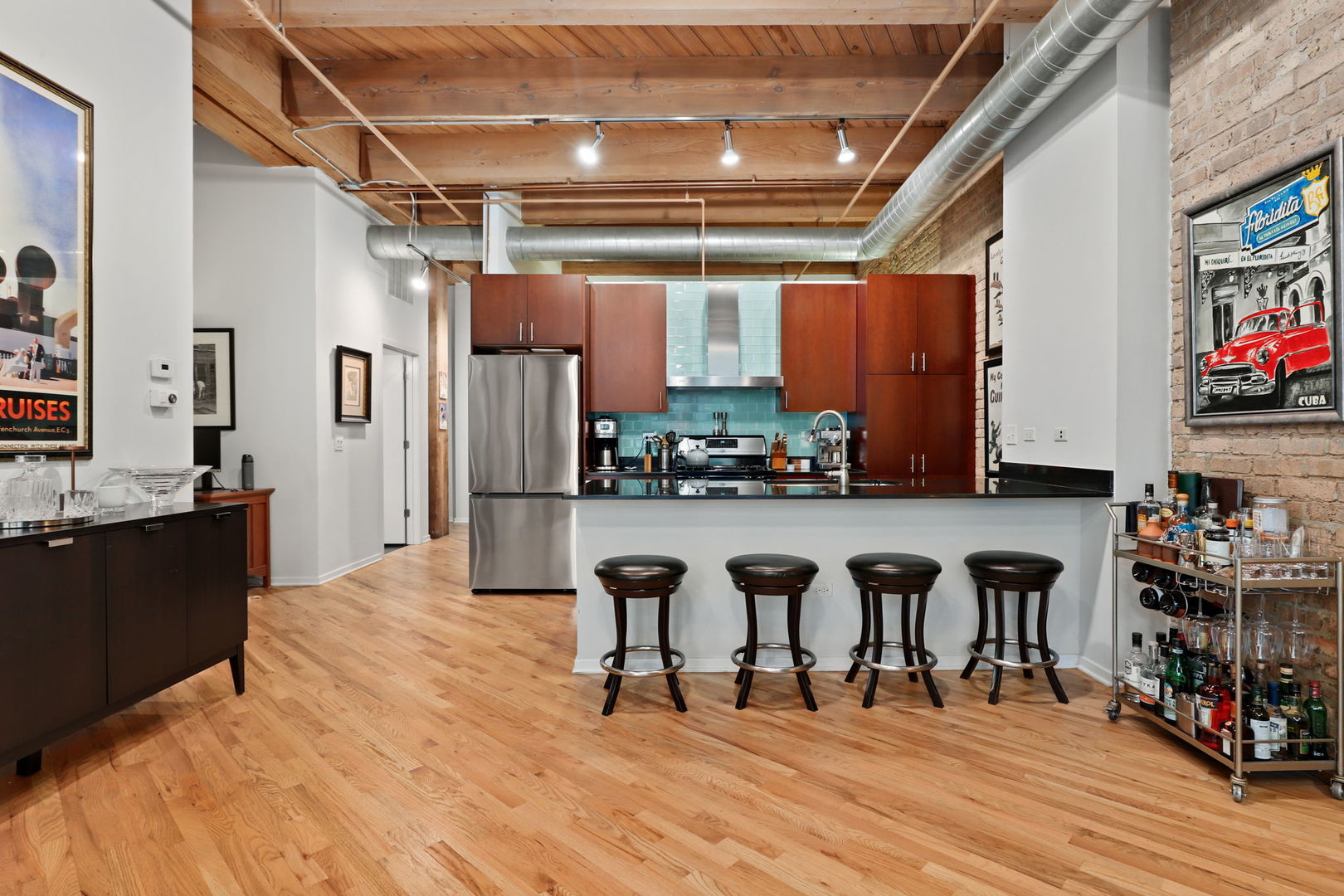 1040 West Adams Street, Unit 224 Chicago, IL 60607 - Photo 9 of 32 a open kitchen with stainless steel appliances granite countertop a refrigerator and stove