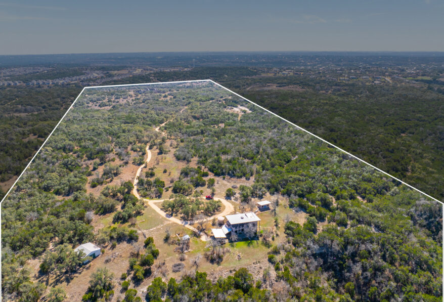 17318 Hamilton Pool Road Austin, TX 78738 - Photo 2 of 21 An expansive acreage property offers privacy surrounded by mature trees and natural landscape.