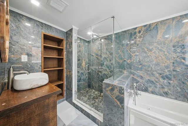 a bathroom with a granite countertop bathtub shower and toilet