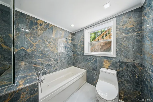 a bathroom with a toilet a sink and bathtub