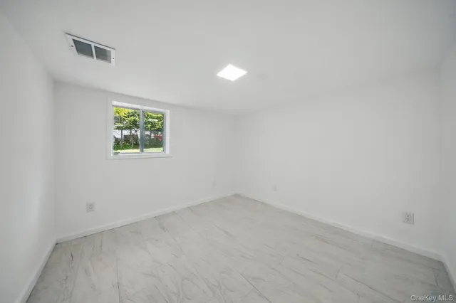 an empty room with windows and closet
