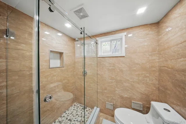 a bathroom with a toilet sink and shower