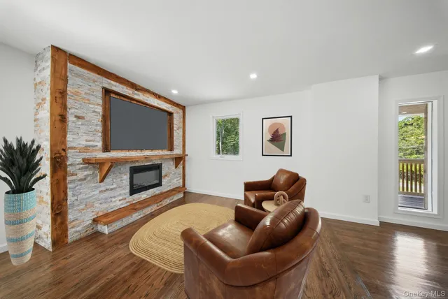 a living room with furniture a fireplace and a flat screen tv