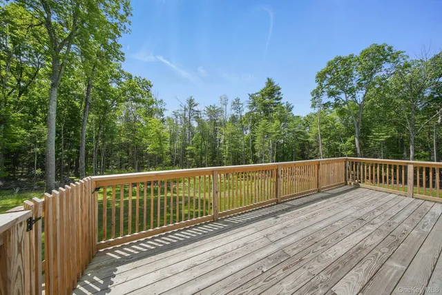 a view of balcony with wooden floor and fence