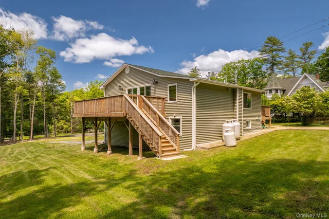 a view of a house with a yard and sitting area