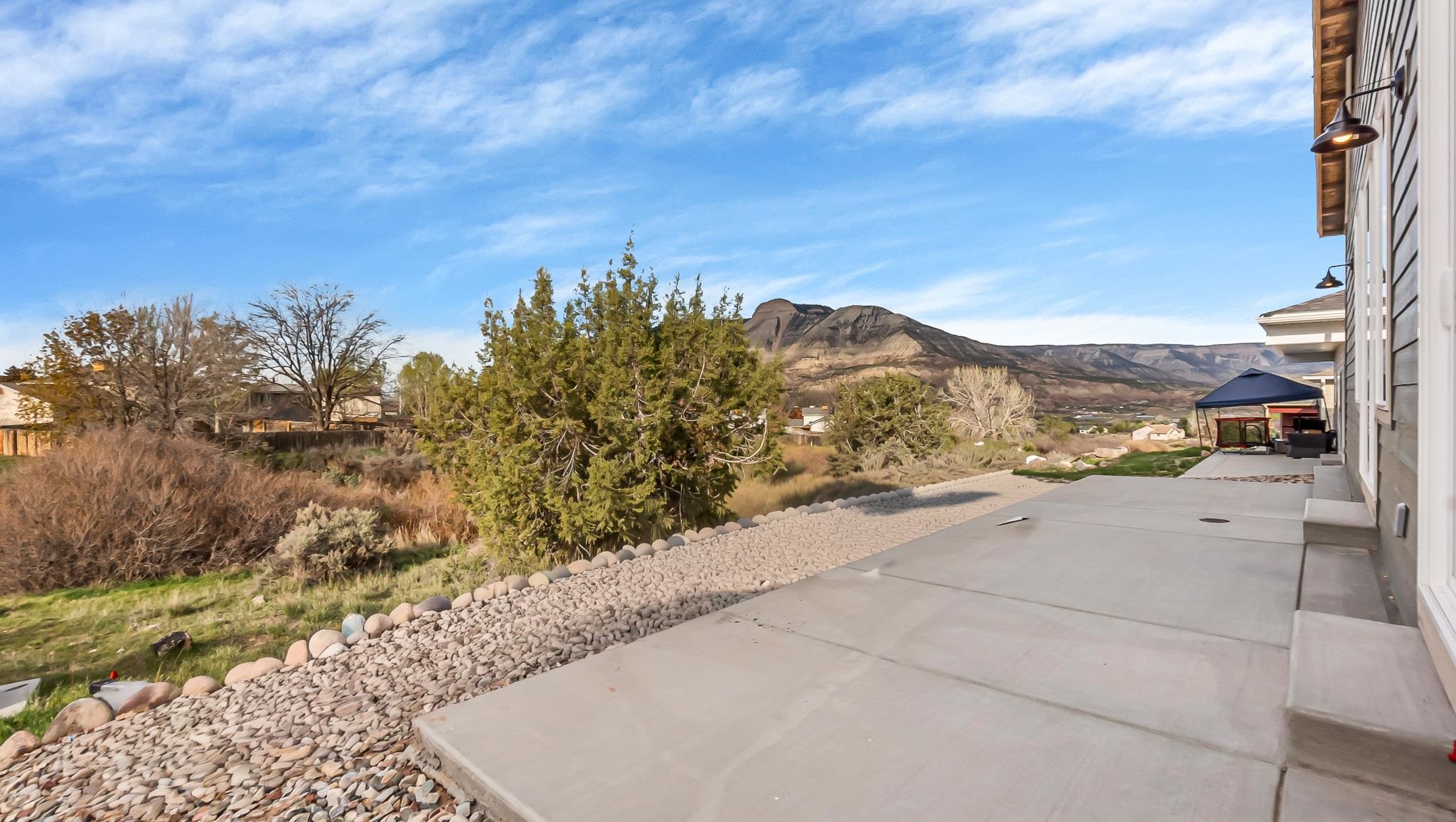214 Limberpine Circle Parachute, CO 81635 - Photo 18 of 24 a view of a dry yard with mountains in the background
