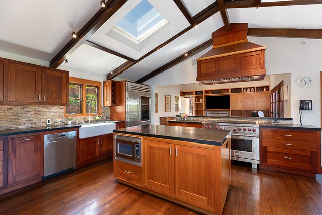 a kitchen with stainless steel appliances granite countertop a stove and a sink