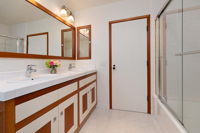 a bathroom with a glass shower door