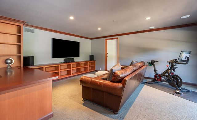 a view of deck with furniture and barbeque oven in a forest