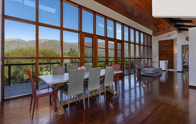 a view of a dining room with furniture window and wooden floor