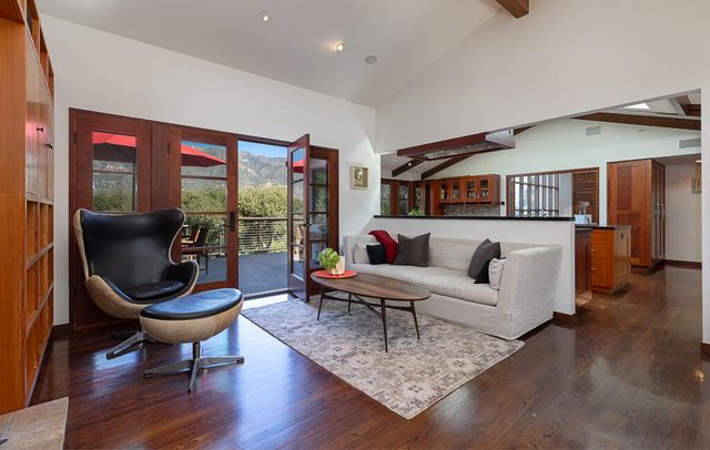 a living room with furniture and a floor to ceiling window