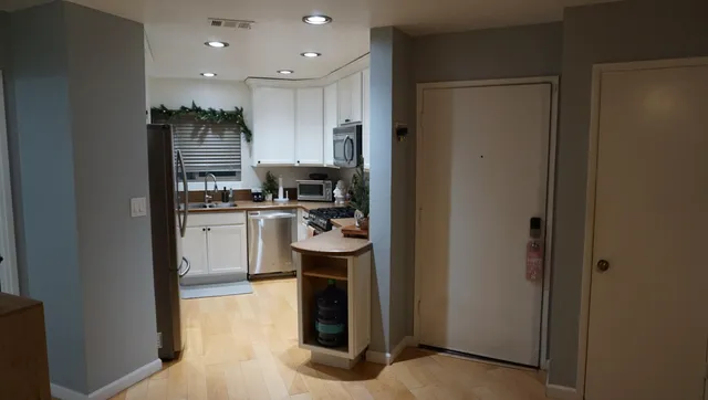 a kitchen with stainless steel appliances granite countertop a refrigerator and a sink