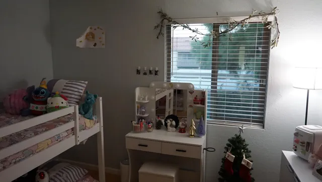 a bedroom with a bed and a television