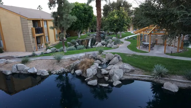 a view of backyard with outdoor seating and green space