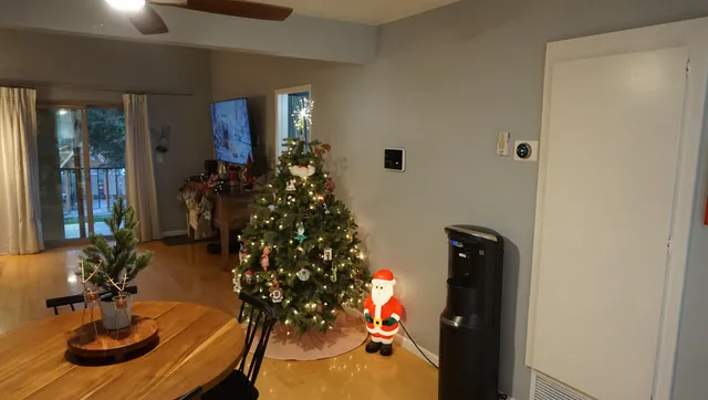 a living room with furniture and a chandelier