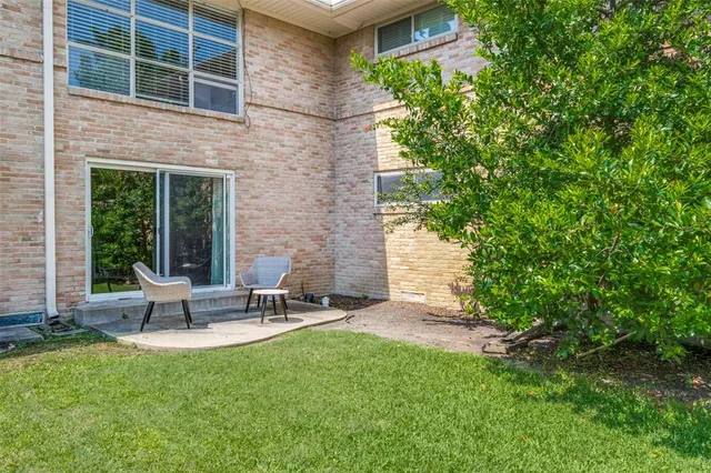 a view of a patio with table and chairs and potted plants
