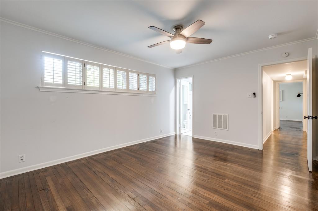 6131 Bandera Avenue, Unit A Dallas, TX 75225 - Photo 8 of 13 a view of an empty room with wooden floor and a window