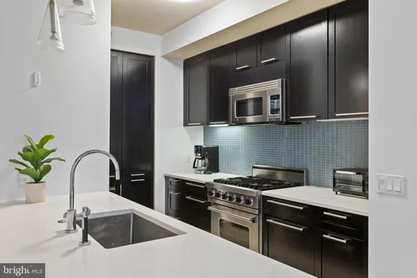 a kitchen with stainless steel appliances granite countertop a sink and cabinets