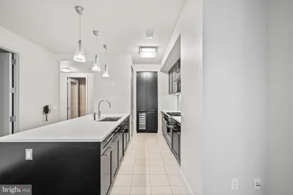 a kitchen with a table chairs and white cabinets